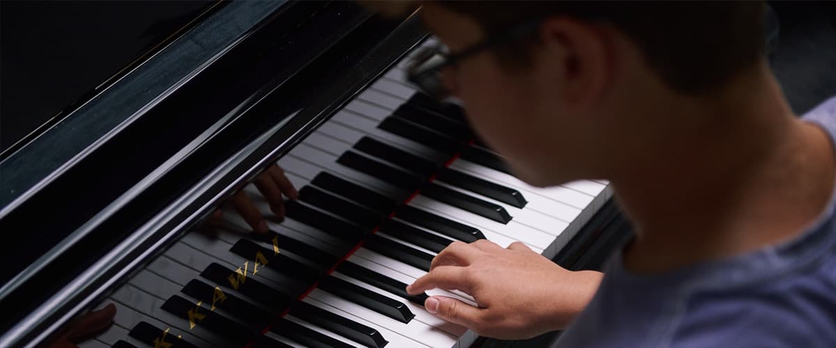 Close-up of a student playing piano